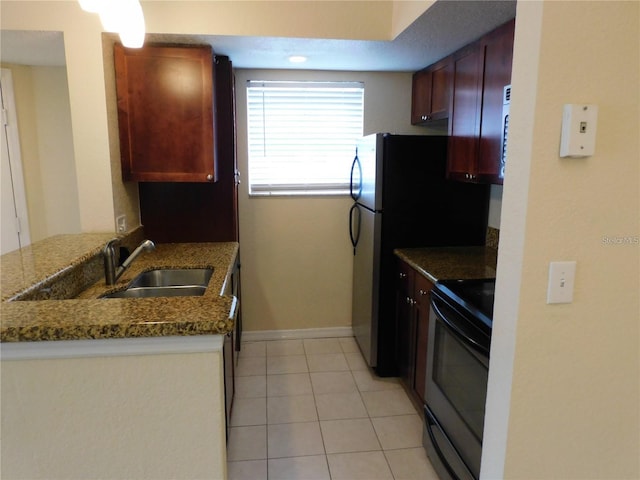 kitchen featuring electric stove, sink, light tile patterned floors, stone counters, and kitchen peninsula