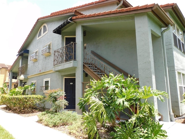 view of side of home with a balcony