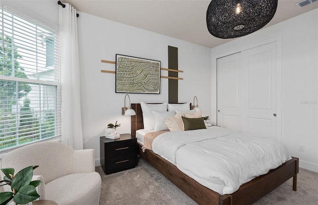 carpeted bedroom featuring a closet