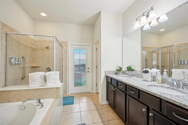 bathroom featuring tile flooring, plus walk in shower, and dual bowl vanity