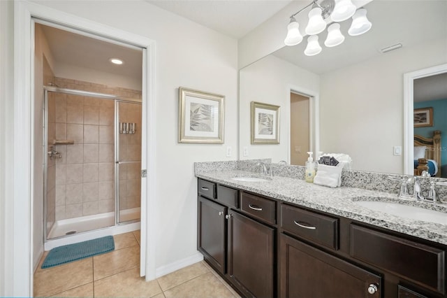 bathroom with double vanity, walk in shower, and tile floors