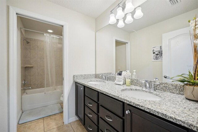 full bathroom featuring oversized vanity, toilet, tile floors, shower / bath combo with shower curtain, and double sink