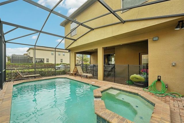 view of pool featuring an in ground hot tub, a lanai, and a patio area