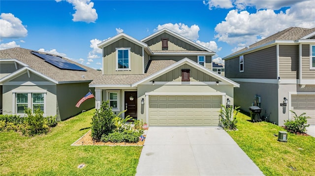 craftsman inspired home featuring a garage and a front lawn