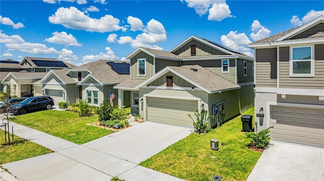 view of front of house featuring solar panels, a garage, and a front yard