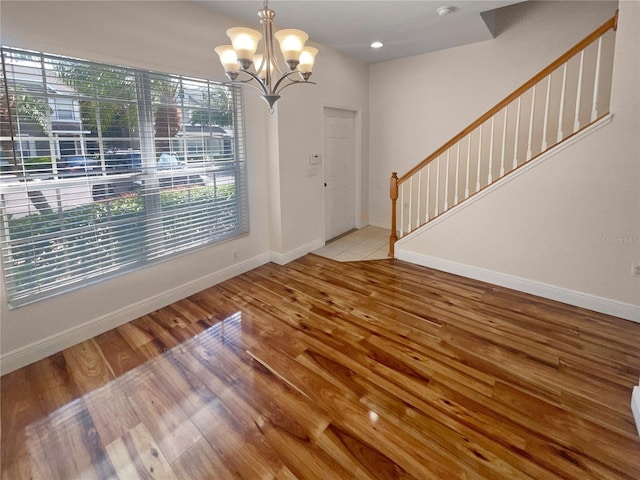 foyer featuring light hardwood / wood-style floors and an inviting chandelier