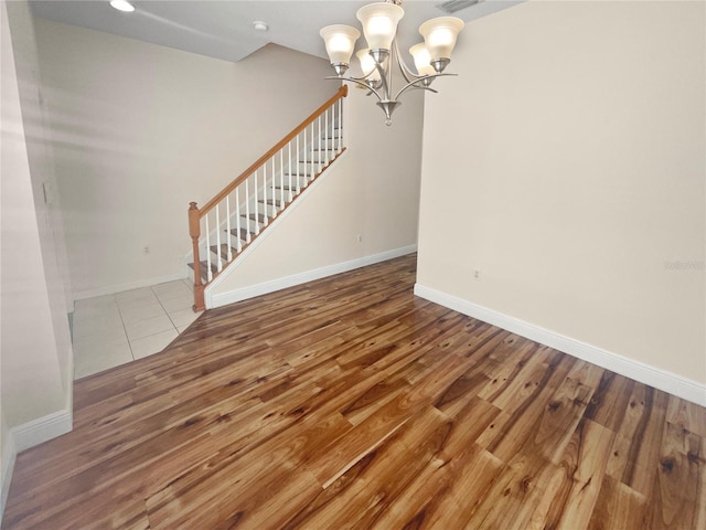 interior space with wood-type flooring and a notable chandelier