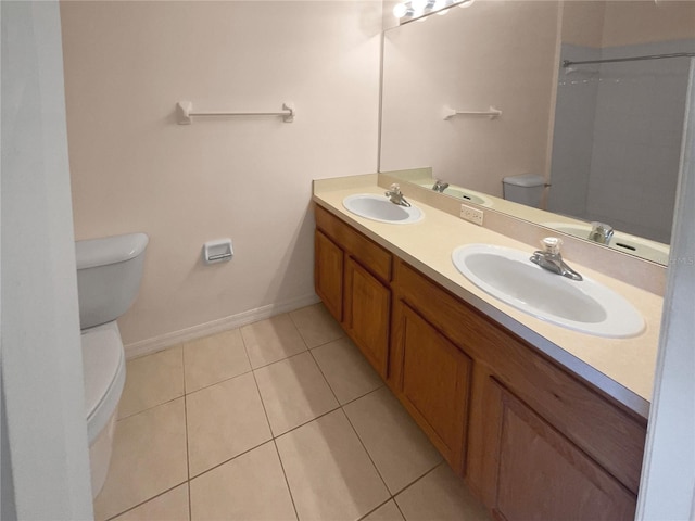 bathroom featuring tile patterned flooring, vanity, and toilet