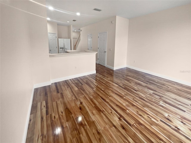 unfurnished living room with hardwood / wood-style flooring