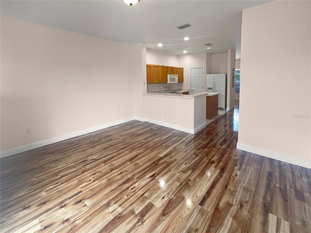 unfurnished living room featuring dark hardwood / wood-style flooring