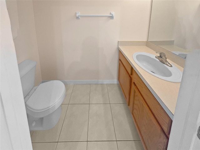 bathroom featuring tile patterned floors, vanity, and toilet