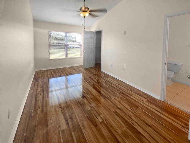 spare room featuring hardwood / wood-style floors, ceiling fan, and vaulted ceiling