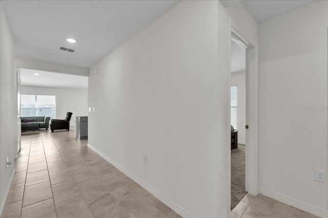 corridor featuring light tile flooring