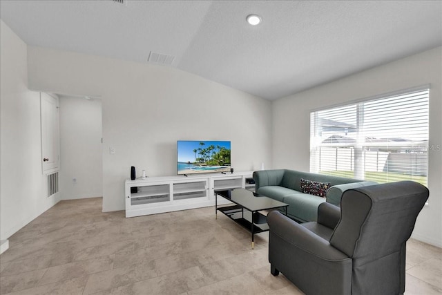 tiled living room with vaulted ceiling