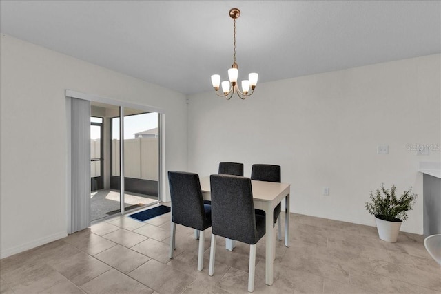 tiled dining room featuring a notable chandelier