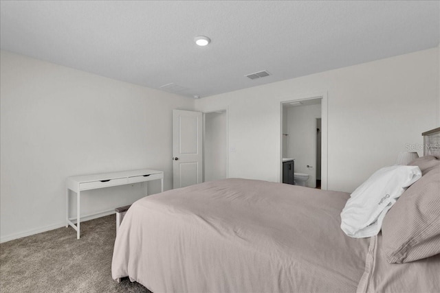 carpeted bedroom featuring ensuite bathroom