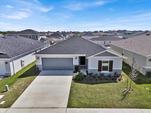 ranch-style home featuring a garage and a front yard