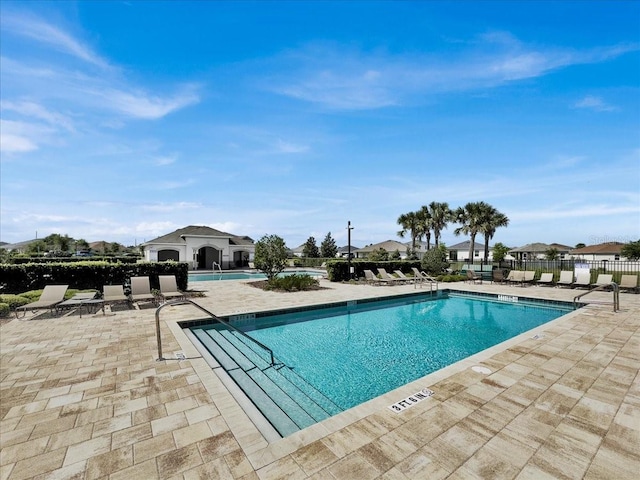 view of swimming pool with a patio