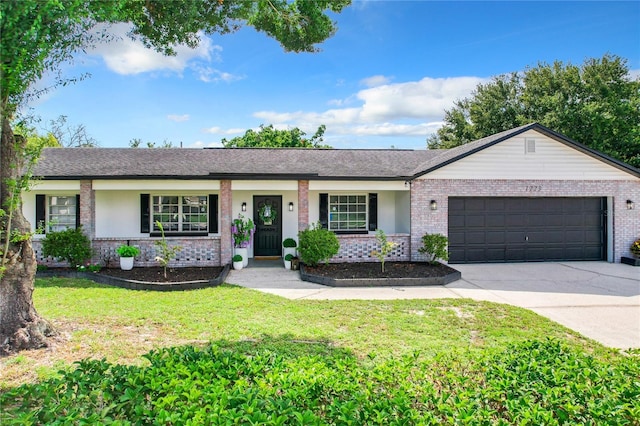 ranch-style home with a front yard and a garage