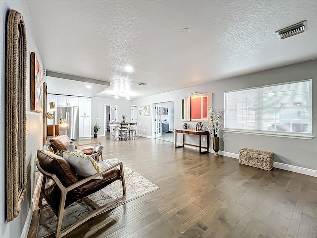 living room with hardwood / wood-style floors and a textured ceiling