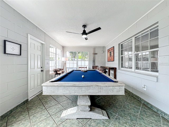 game room with ceiling fan, tile patterned flooring, a textured ceiling, and pool table