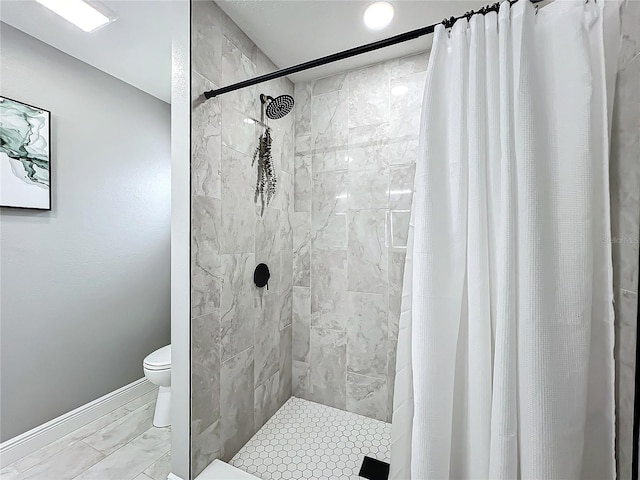 bathroom featuring curtained shower and toilet