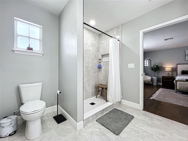 bathroom featuring toilet and walk in shower