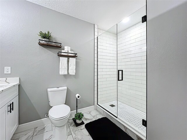 bathroom featuring vanity, toilet, and an enclosed shower