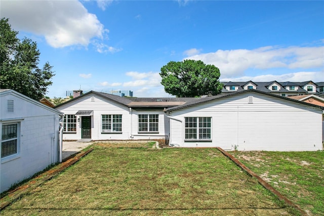 back of house with a lawn