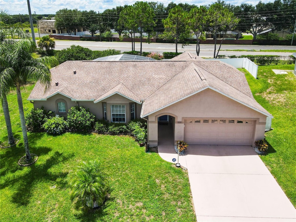 single story home with a front yard and a garage