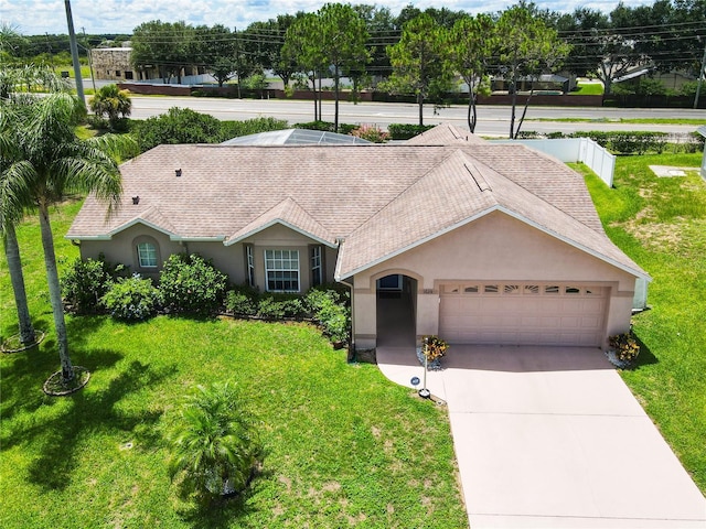 single story home with a front yard and a garage