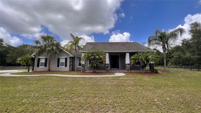 view of front of house with covered porch and a front lawn