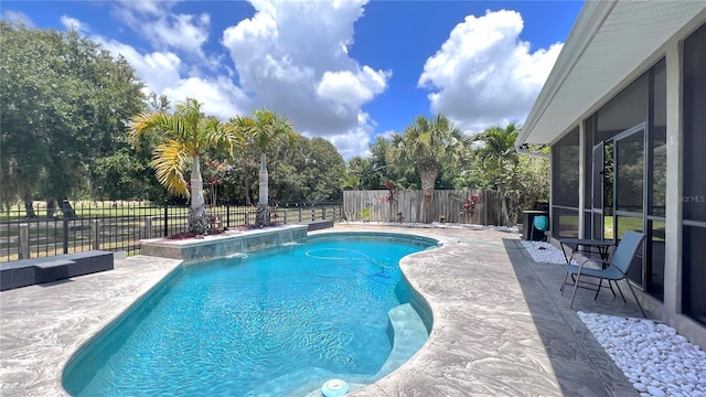 view of pool featuring a patio area, a sunroom, and pool water feature