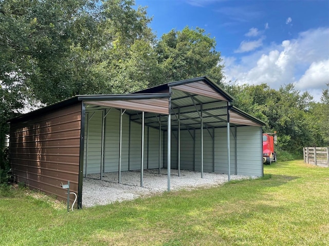 view of outdoor structure with a carport and a lawn