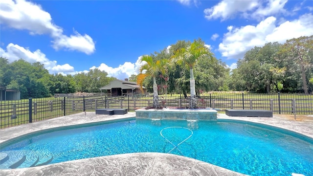 view of swimming pool with a hot tub