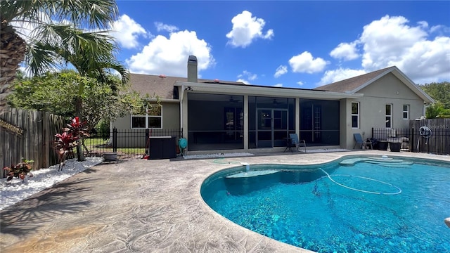 view of swimming pool featuring a patio and a sunroom