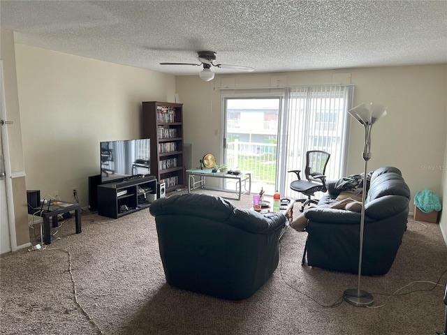 carpeted living room featuring ceiling fan and a textured ceiling