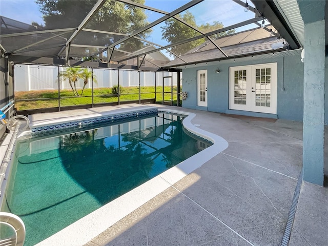 view of pool with french doors, a patio, and a lanai