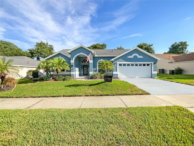 ranch-style home with a garage, central air condition unit, and a front lawn