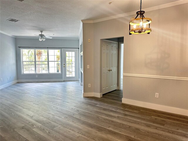 unfurnished room with ceiling fan, ornamental molding, dark hardwood / wood-style floors, and a textured ceiling