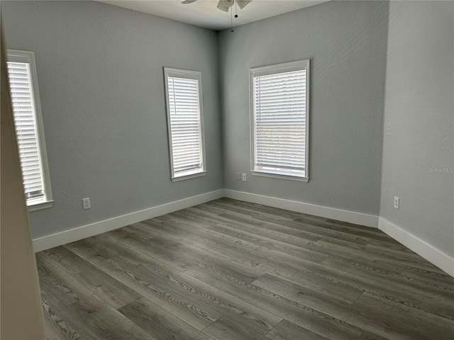 spare room with hardwood / wood-style floors and ceiling fan