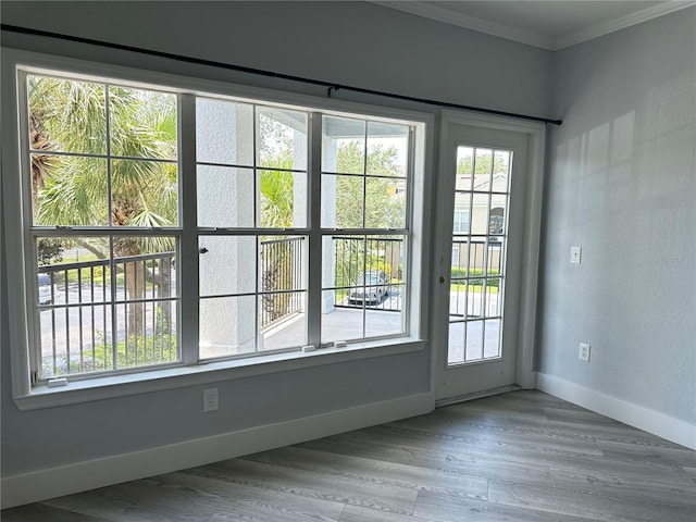 doorway to outside with crown molding and light hardwood / wood-style floors