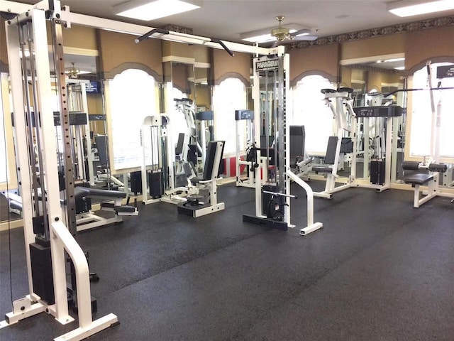 gym with ceiling fan and plenty of natural light