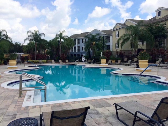 view of pool with a patio area and a jacuzzi