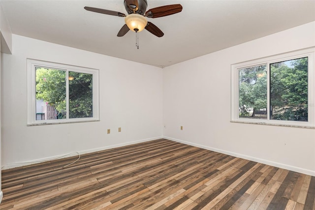 unfurnished room with ceiling fan and dark wood-type flooring