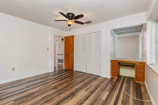 unfurnished bedroom with dark hardwood / wood-style flooring and ceiling fan