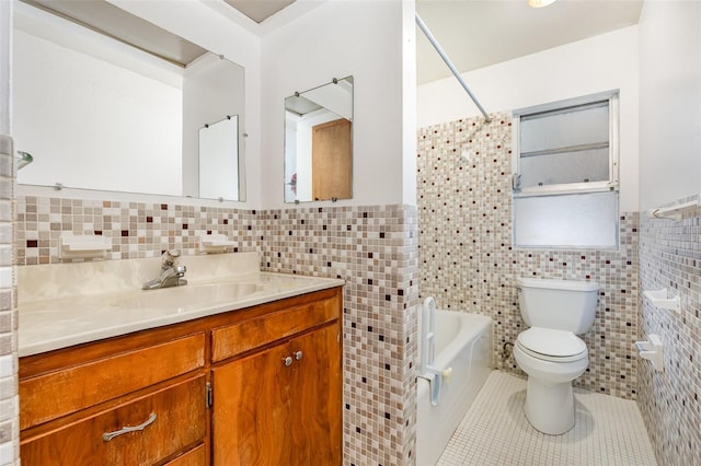 full bathroom featuring toilet, vanity, tile patterned floors, and tile walls