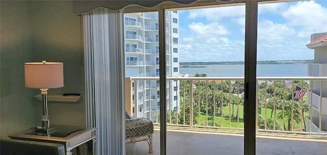 balcony featuring a water view and grilling area