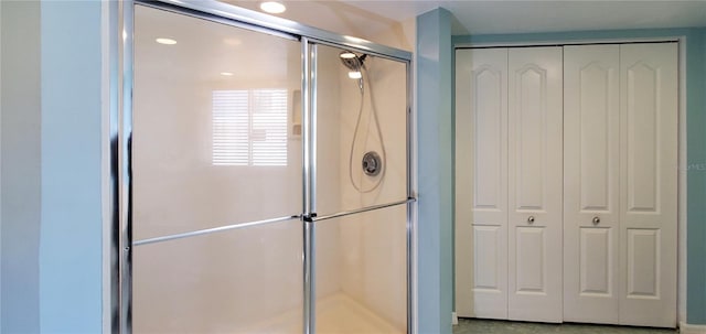 bathroom with a shower with door