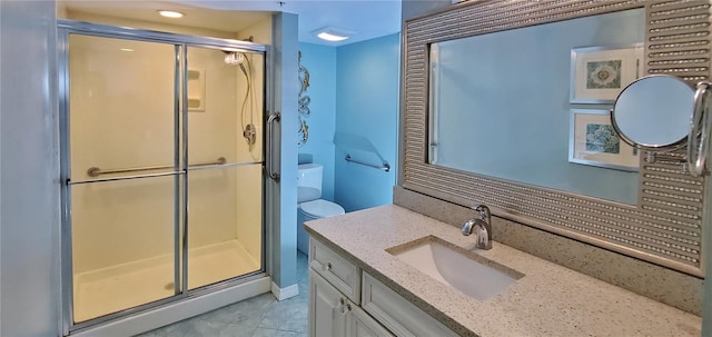 bathroom with tile patterned floors, vanity, and walk in shower